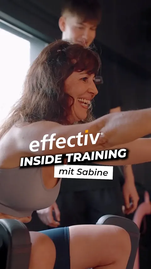 Sabine beim Training im effectiv, lachend an einem Kraftgerät.